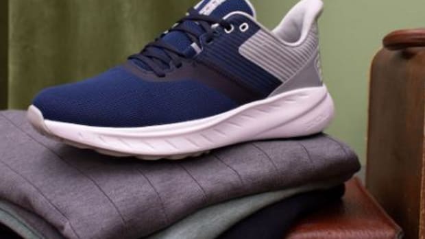 Side view of navy and white Footjoy golf shoes.